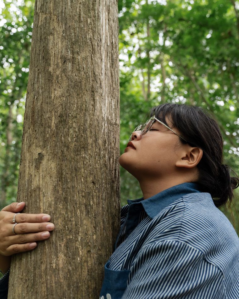 Forest bathing, embracing a tree.