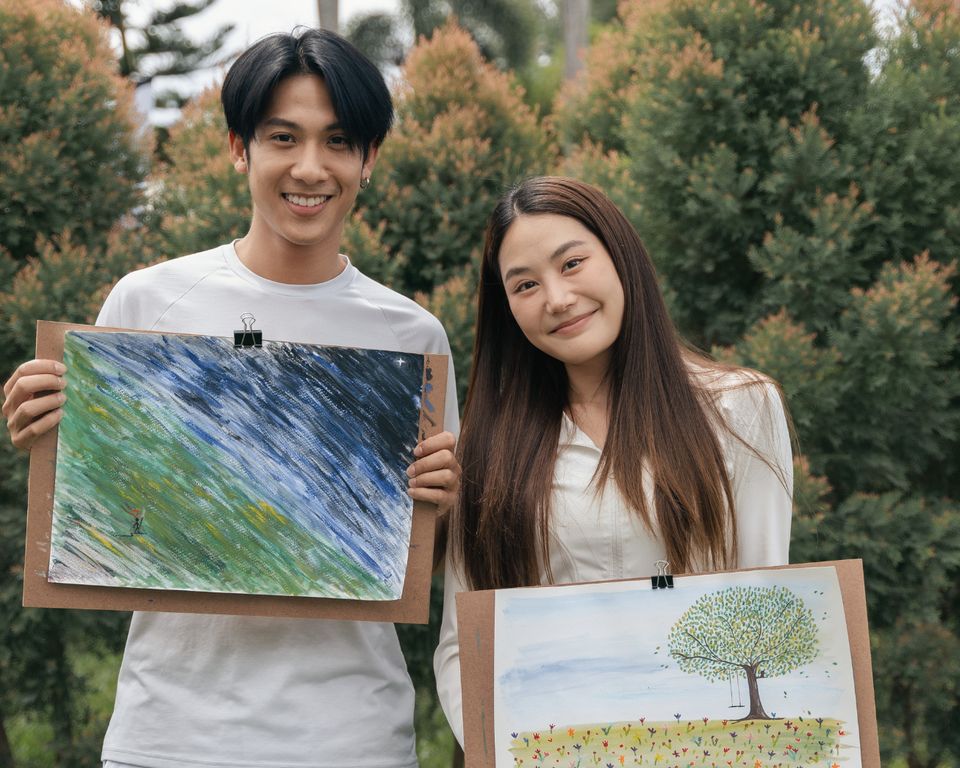 A couple with their art during Recharge Your Love.